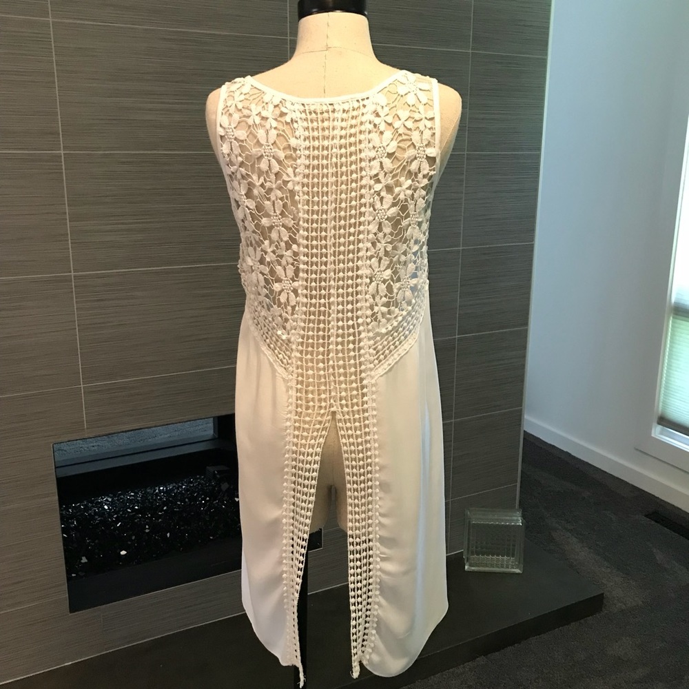 Sheer, white, high-low top with crochet details.